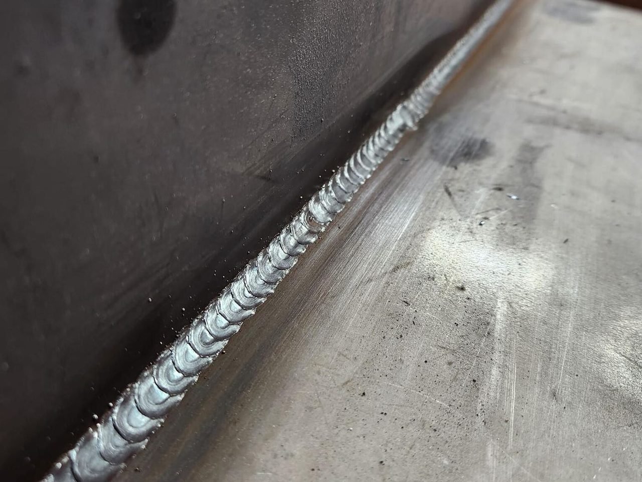 Hand-welded quarter-inch plate steel seam