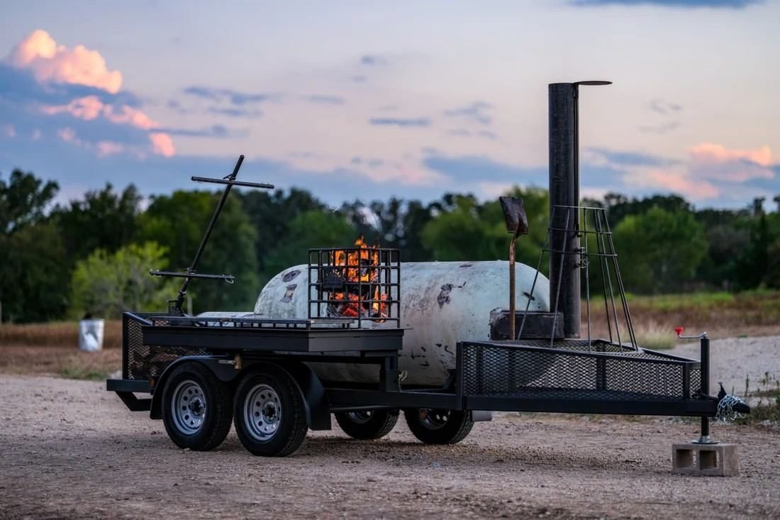 An Apex offset smoker at a cookout